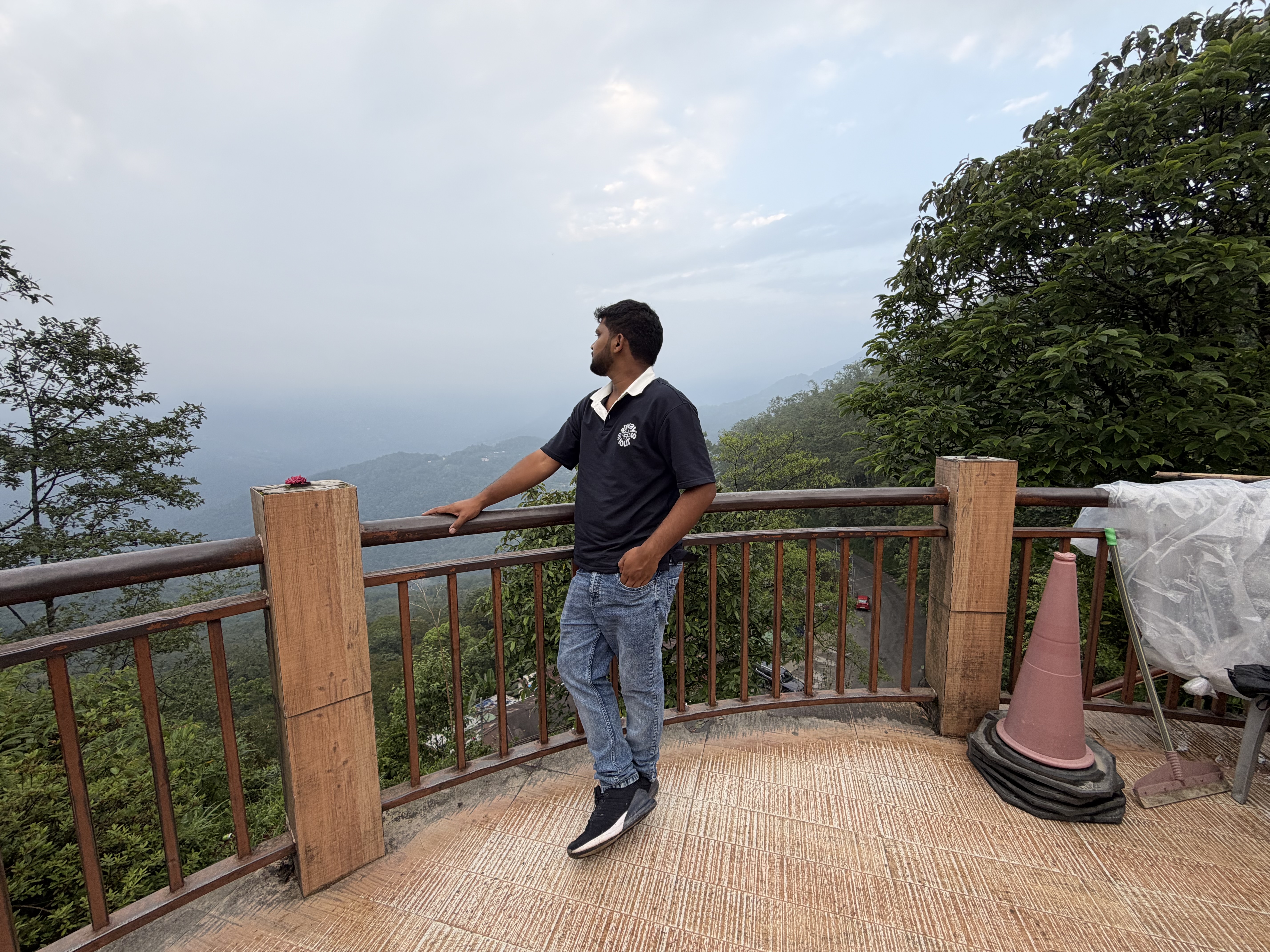 Standing at Hanuman Tok viewpoint platform with the green valleys of Sikkim stretching into the distance